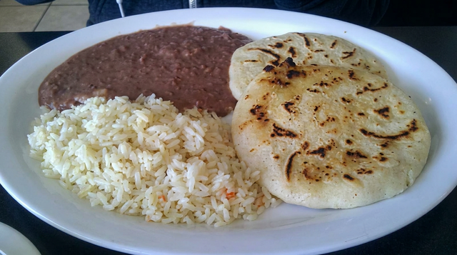 Two Pupusas con Arroz y Frijoles.